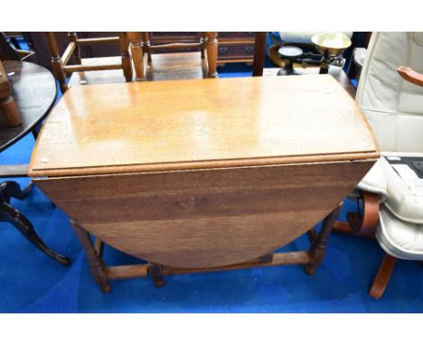 An early 20th Century light oak gate leg dining table