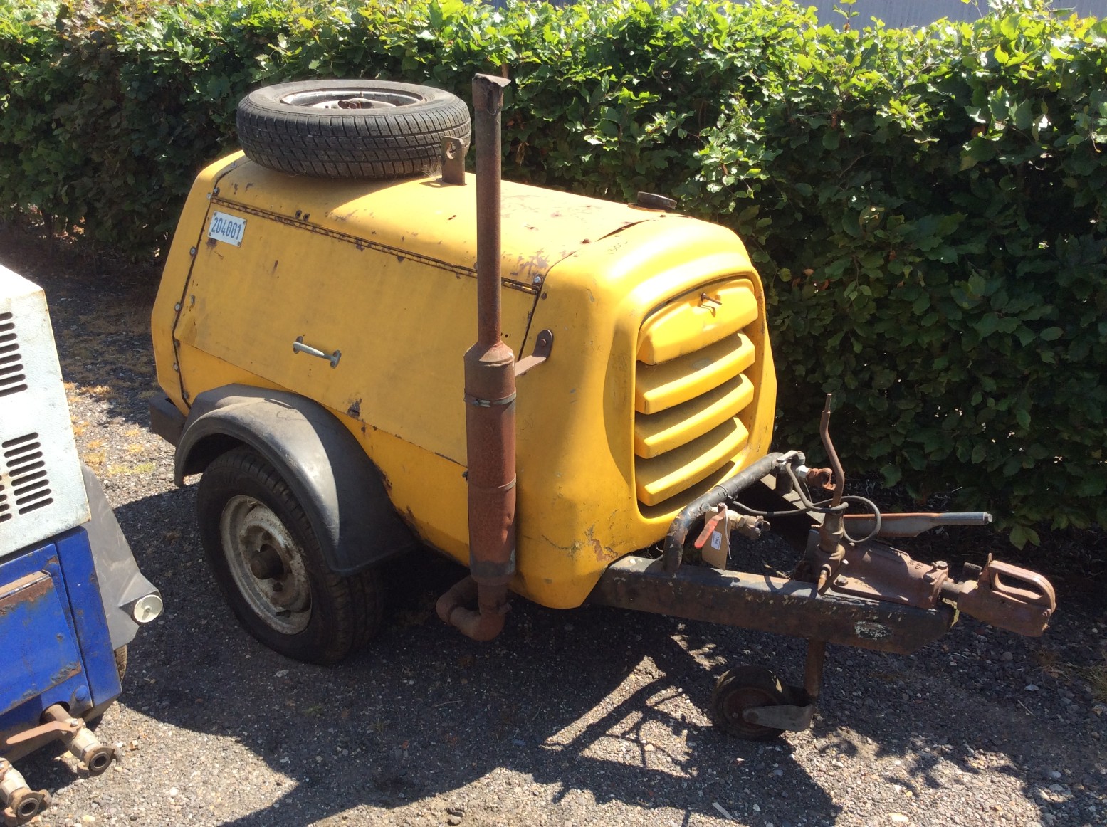 Hydrovane road tow compressor with four cylinder Perkins engine.