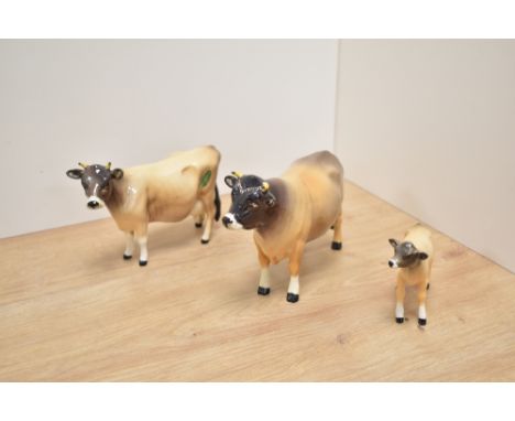 A Beswick Pottery Jersey cattle family, comprising Bull Champion Dunsley Cow Boy, number 1422, Cow Champion Newton Tinkle, nu