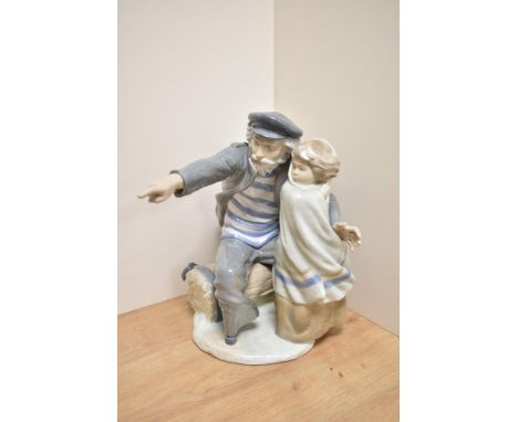 A large Nao porcelain figure group 'Waiting Time for the Fisherman' modelled as an young child and bearded sea captain, looki