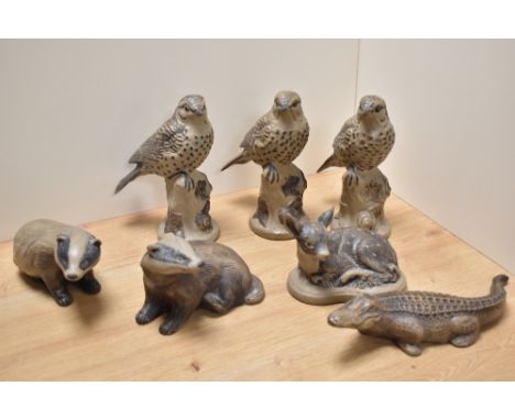 A group of seven Poole pottery stoneware animal and bird studies, comprising three thrushes, two badgers, a fawn and crocodil