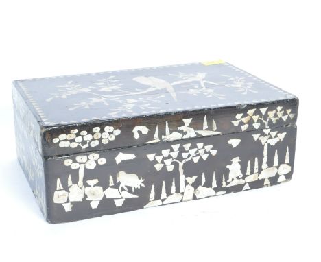 A large early 20th century mother of pearl box having an ebonised case over foliate &amp; avian detailing. Measures 13cm x 36