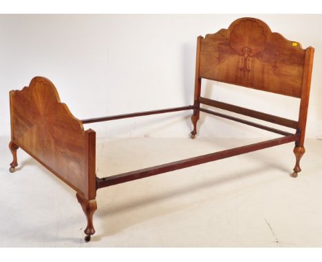 An early 20th century Art Deco burr walnut bed frame having inlaid sunburst motifs to the headboard and footboard raised on c