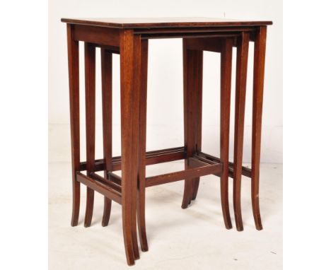 An&nbsp; Edwardian solid mahogany nest of three tables of graduating forms. The tables&nbsp; having rectangular panel tops ov