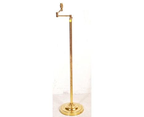 A retro vintage mid 20th century Hollywood Regency / Italian swing arm articulated brass lamp having a single column support 