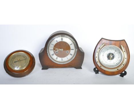 A vintage retro mid 20th century Smiths oak cased mantle clock having a chrome dial with roman numeral in black to the chapte