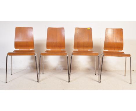 A set of four vintage retro mid 20th century industrial dining chairs. Each having a teak ply panel back and seat raised upon