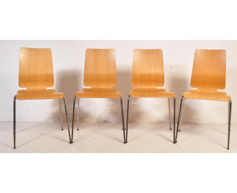 A set of four vintage retro mid 20th century industrial dining chairs. Each having a teak ply panel back and seat raised upon