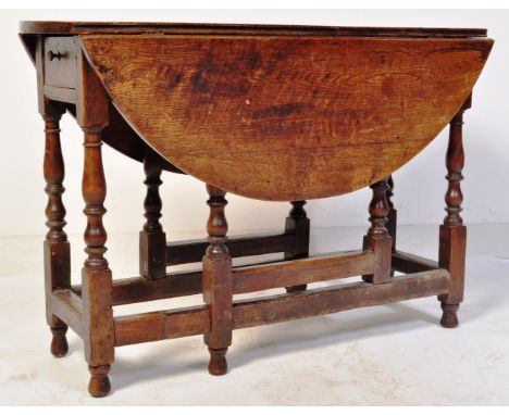 An 18th century country oak and elm drop leaf / gate leg occasional dining table. The table&nbsp; with single cutlery drawer 
