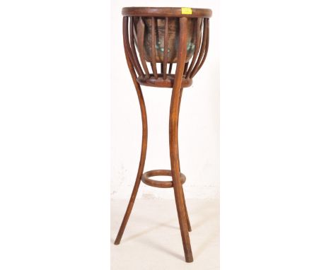 An Edwardian mahogany planter -&nbsp; jardiniere. The planter having a brass bowl to the top, enclosed in a oak pierced rail 