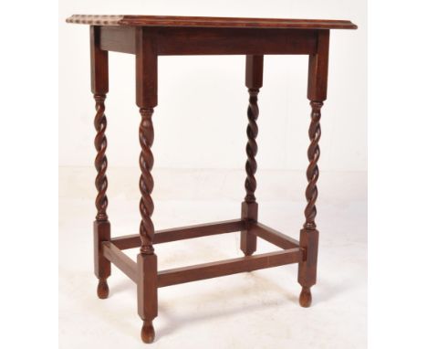 A vintage early 20th century circa. 1930's oak hall side table. The table top having a chamfered edge raised over barley twis