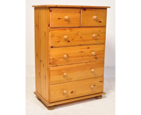A vintage 20th century country pine chest of drawers having two drawers over a bank of four drawers, each with knob handles. 