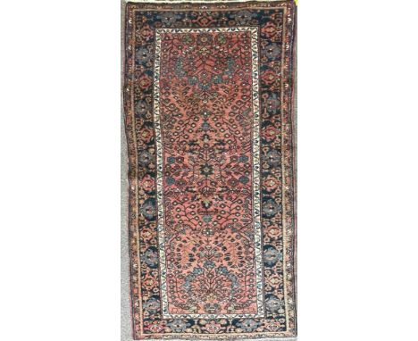 A vintage 20th century Persian Islamic runner rug carpet having polychrome floral detailing to the central panel set within a