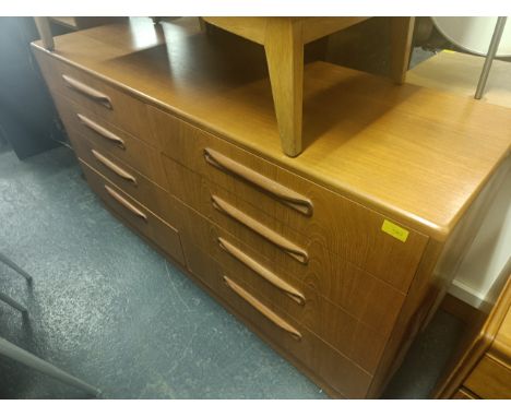A retro vintage mid 20th century teak sideboard in the manner of G Plan having two banks of four drawers with lipped handles.
