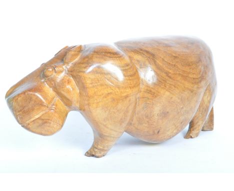 A large vintage 20th century African tribal hardwood hand carved hippopotamus sculpture. The sculpture appears in overall ver