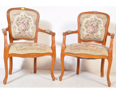 A pair of 20th century Louis XVI French style mahogany fauteuil armchairs. The chairs having serpentine armchairs with back r