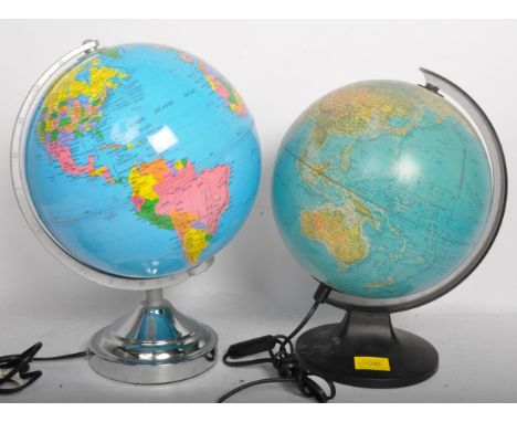Two vintage retro 20th century light up desk globe lamps. Each lamp being raised on a plastic circular base. Measures 35cm ta