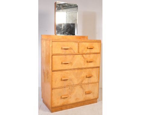 An Art Deco circa 1930s walnut dressing chest having a mirror of rectangular form atop a two over three drawers with shaped h