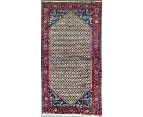 A vintage 20th century Persian Islamic having a central foliate medallion surrounded by a geometrically patterned border. Tas