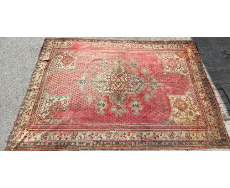 A large vintage 20th century Persian Islamic rug carpet having a central floral medallion set within a geometrically patterne