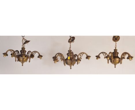 A trio of vintage 20th century brass chandelier electrolier ceiling lights. Each having four arms with Art Nouveau manner fol