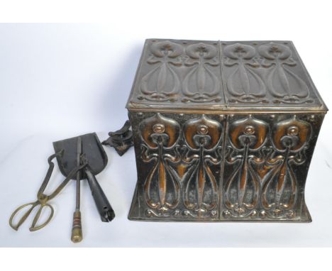 An early 20th century Art Nouveau coal bucket having stylised floral decoration in relief throughout. The bucket has a single