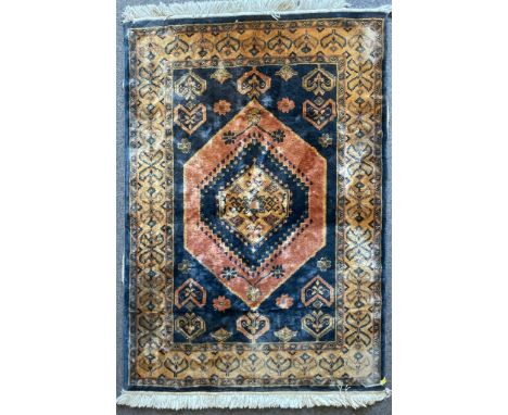 A vintage 20th century Persian Islamic rug / carpet having a central medallion within a foliate patterned border. Tassels to 