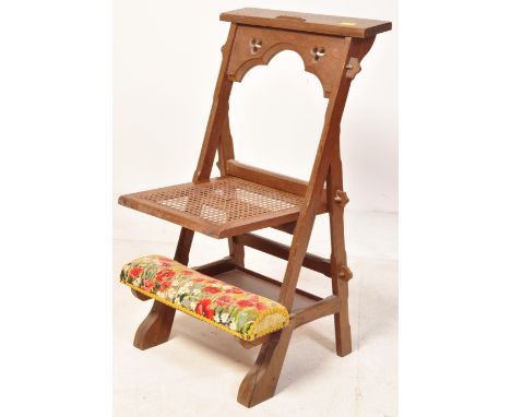 A Victorian 19th century carved oak Pugin manner ecclesiastical prie dieu chair stand. Carved a-frame with caned panel centre