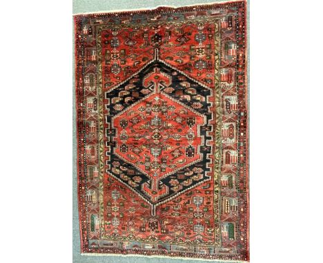 A 20th century Persian Islamic Zanjan rug carpet having a central panel with geometrically patterned detailing set with a pat