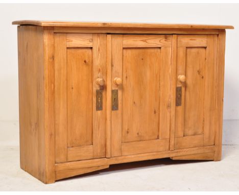 A vintage 20th century Scandinavian pine wood sideboard credenza. The sideboard having three panelled cupboard doors with kno