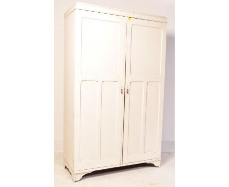 A vintage mid 20th century oak Aw-lyn gentlemans wardrobe. The wardrobe painted in a white tone and having twin doors with a 