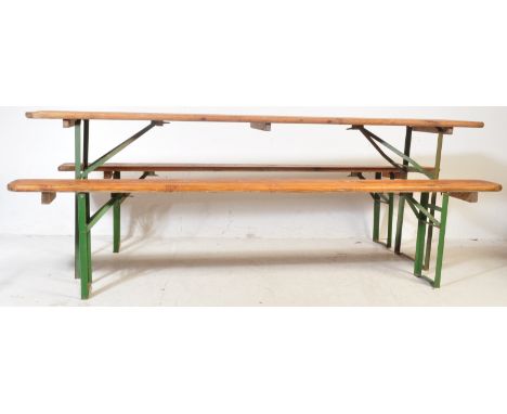 A vintage 20th century pine German beer hall refectory dining table and pair of refectory benches. Each having a pine top wit