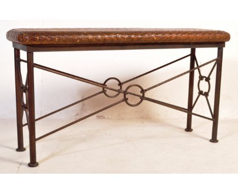 A vintage 20th century rattan and cast iron console table / high bench having a rectangular rattan top with circular iron sup