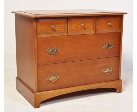 A retro vintage 20th century Stag Minstrel African Cherrywood lowboy chest of drawers having a flared top over a bank of draw
