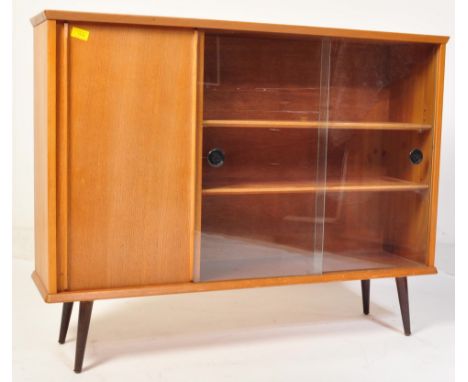 A vintage retro mid 20th century teak display bookcase cabinet having a cupboard besides glazed twin sliding doors opening to