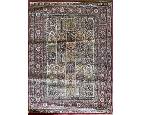 A vintage 20th century Persian Islamic rug carpet having geometric motifs to the central panel set within a patterned border.