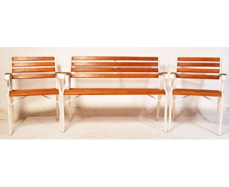 A set of vintage 20th century cast metal garden furniture comprising of a teak slatted garden bench together with two matchin