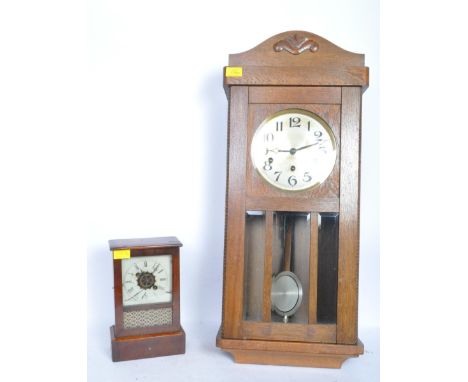 A 20th century oak case wall clock having a brass clock face with arabic numerals to the chapter ring. Together with a early 