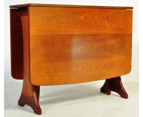 A retro vintage mid 20th century circa 1960s teak space saving dining table having a chamfered edge with drop leaves and a ga