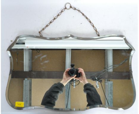 A vintage retro mid 20th century circa. 1950's bevelled edge mirror of armorial form with hanging chain to back. Measures 61c