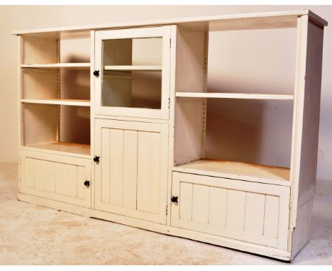 A vintage 20th century open faced painted pine shelving unit&nbsp; - bookcase having an arrangement of shelves over three sin