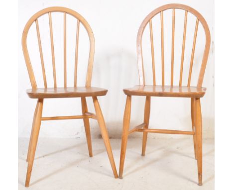 Two vintage mid 20th century wooden dining chairs. The lot to include a teak Ercol Windsor hoop back dining chair &amp; a bee