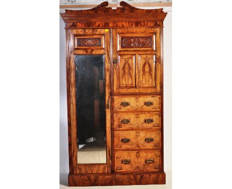 A late Victoria walnut Art Nouveau wardrobe compactum. The wardrobe having a full length mirror opening to reveal shelved int