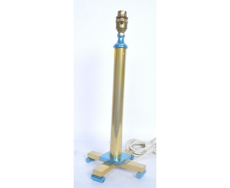 A 20th century brass Art Deco lamp having raised on four point base with scrolled feet. The lamp is decorated in a brass and 