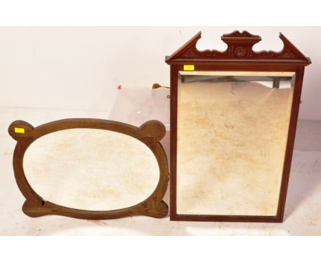 An early 20th century Art Nouveau circa 1920s wall mirror of oval form together with another mirror.