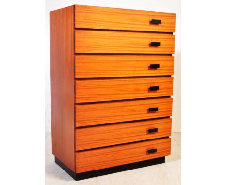 A retro vintage mid 20th century Danish inspired teak wood chest of drawers of upright form having seven drawers with handle 