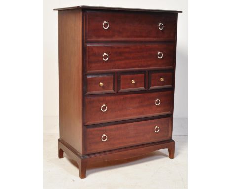 A retro vintage 20th century Stag Minstrel African Cherrywood tallboy chest of drawers having a flared top over an arrangemen
