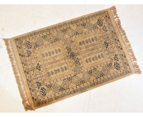 A vintage 20th century Persian Iranian Islamic carpet rug having two square panels with black geometric detailing on a black 