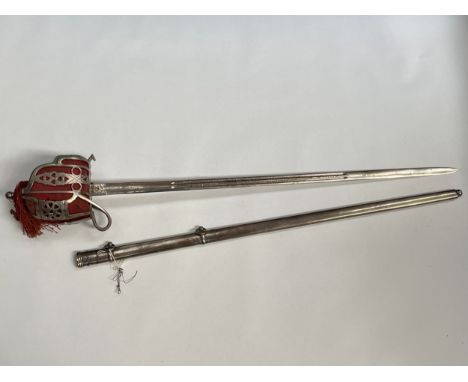 A reproduction Scottish basket hilted broadsword, thistle and King's crown design to twin fuller blade, steel scabbard 
