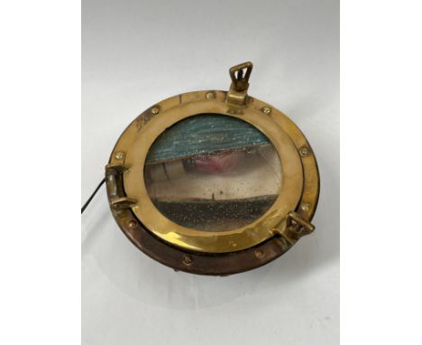 A vintage brass framed porthole, illuminated. COLLECTORS ELECTRICAL ITEM: REWIRING REQUIRED 